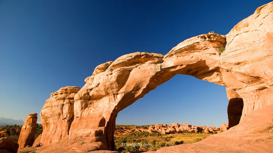 Hidden Log Creek Arches formation showing natural sandstone archway with forest backdrop